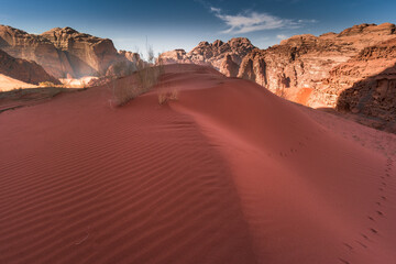 Obraz na płótnie Canvas Red sand dunes on Wadi Rum desert in Jordan. Spectacular landscape of orange desert.