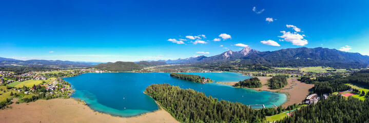 Faaker See in Carinthia. Aerial view to the beautiful lake and the Mittagskogel mountain in the south of Austria.