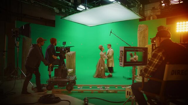 On Film Studio Set Clapperboard Shuts and Director Says Action, Cameraman Starts Shooting Green Screen Scene with Two Talented Actors Wearing Renaissance Clothes Talking. History Costume Drama Movie
