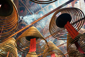 Burning incense coils inside Man Mo Temple, Sheung Wan, Hong Kong - obrazy, fototapety, plakaty