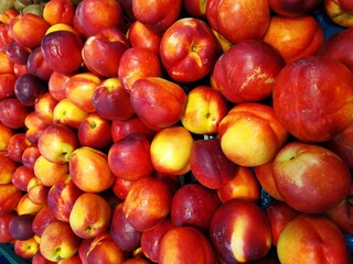 Juicy and ripe looking raw peaches , ready for sale in market. Close up shot.