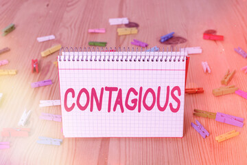 Handwriting text writing Contagious. Conceptual photo transmissible by direct or indirect contact...