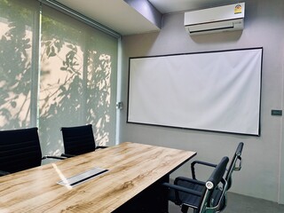 An empty business meeting room with presentation screen board in modern office. Interior of meeting...