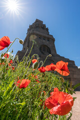 Leipzig, Germany - May 30 2020: Red poppy flowers at the Monument to the Battle of the Nations in...