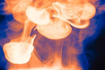 Clouds of colored flowing smoke on a dark background. Smoky extravaganza. Flying smoky vague...