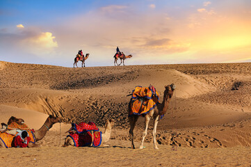 Camel caravan at Thar desert Jaisalmer Rajasthan with view of tourist enjoying desert safari at...