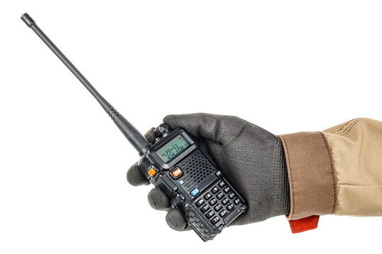 Worker hand in black protective glove and brown uniform holds modern walkie talkie isolated on white background