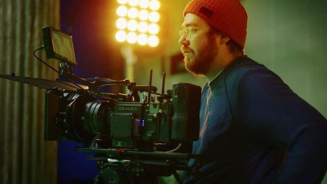 Portrait of Cameraman on Railway Trolley Shooting Green Screne Scene. Professional Crew on Big Budget Filmmaking. Film Studio Set Shooting Historical Movie Green Screen Scene. Slow Motion Arc Shot