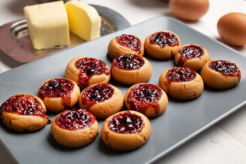 Sweet berry jelly cookies on grey plate.