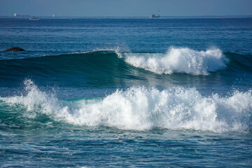 View from above to the blue ocean waves on surfing spot in the tropical island
