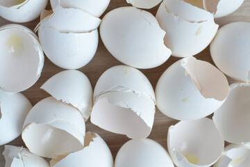A pile of broken empty white eggshells top view