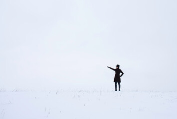 winter scene with a man pointing at something 