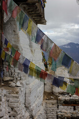 Buddhist Praying Flags Waving outside a White Buddhist temple in the Indian Himalaya