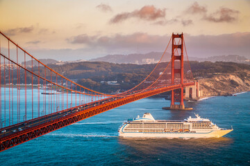 Golden Gate Bridge with cruise ship at sunset, San Francisco, California, USA