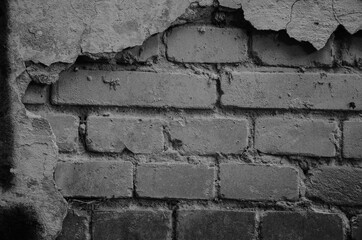Peeled brick wall, gray background, texture of old bricks.