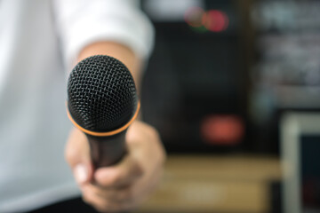 Reporter or Journalist media holding microphone interview news or press conference conducting business for speech or teacching at seminar conference room