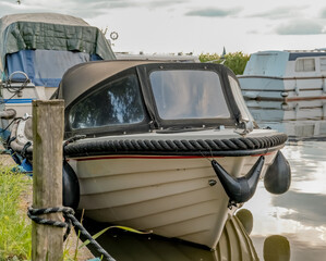 Front end view of a small motor boat tied up in a private mooring off Thurne Dyke in the Norfolk...