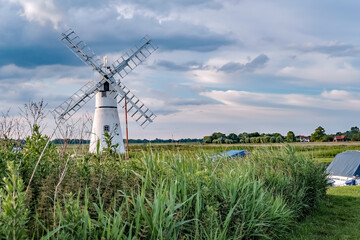  The infamous Thurne mill on the riverbank at Thurne Mouth in the Norfolk Broads National Park on a...