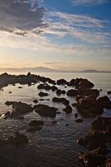Fototapeta premium sunrise over rocky coastline 