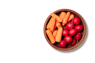 Radishes and carrots on a plate on a light background top view