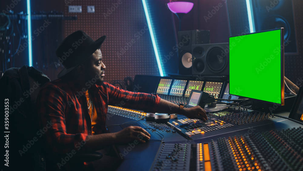 Poster stylish audio engineer producer working in music record studio, uses green screen computer, mixer bo