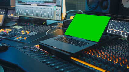 Modern Music Record Studio Control Desk with Green Screen Chroma Key Laptop, Equalizer, Mixer and...