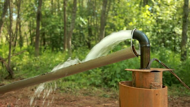 Powerful Water Flowing from a Pipe Pump.Water Pump.Water well drilling.Close-up.
