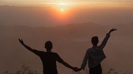 portrait. lovers cuddle at dawn on the volcano Batur. Bali Indonesia