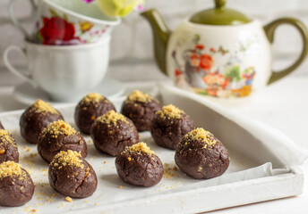Delicious homemade chocolate cakes and tea dishes on the table.