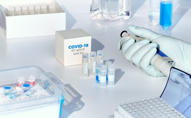Fototapeta na wymiar Quick novel COVID-19 coronavirus test kit. 2019 nCoV pcr diagnostics kit. Hand in glove with tubes. RT-PCR kit detects covid-19 corona virus in patients samples. Real-time PCR amplification reagents.