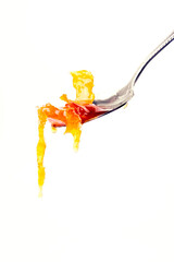 dripping orange jam from a spoon