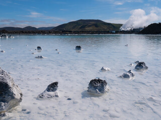 Blue lagoon water in lava field landscape, natural geothermal spa attraction, Iceland