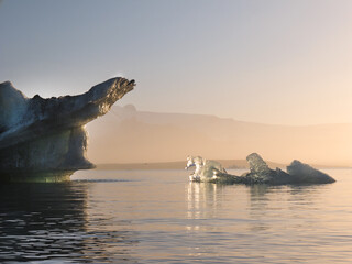 View of icebergs in Jokulsarlon glacier lagoon at midnight sunset, Iceland