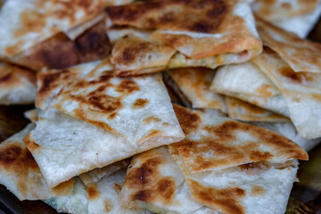Appetizer for beer with thin pita bread stuffed with barbecue.