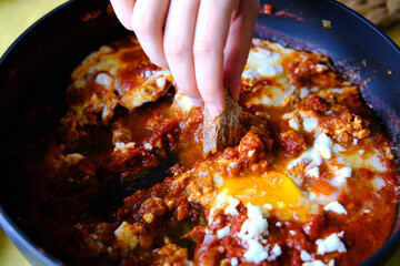 Shakshuka in a Frying Pan. Eggs Poached in Spicy Tomato Pepper Sauce.