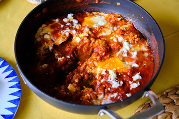 Shakshuka in a Frying Pan. Eggs Poached in Spicy Tomato Pepper Sauce.