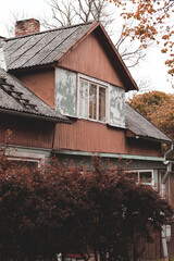 old red wooden house with stairs on roof