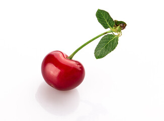 fresh cherry berries with a green leaf isolated on a white background