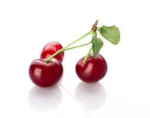 fresh cherry berries with a green leaf isolated on a white background