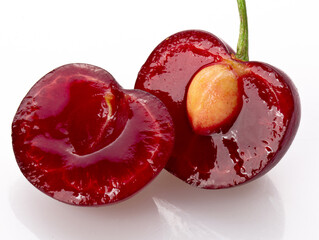 cherries cut in half  isolated on a white background 