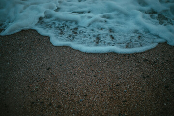 Sea foam on the beach close-up
