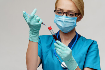 medical doctor nurse woman wearing protective mask and gloves - holding virus blood test tube and syringe