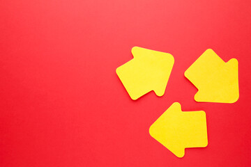 Paper sticky notes in shape of arrow on red background