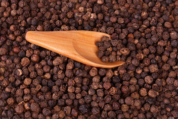 black pepper peas in a wooden spoon and scattered 