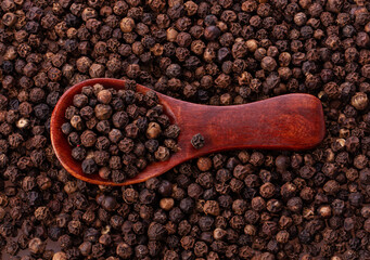 black pepper peas in a wooden spoon and scattered 