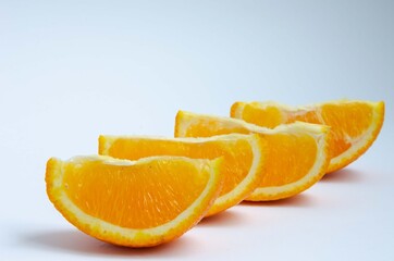 Naklejka na ściany i meble Sliced orange close up, slices of juicy orange. 