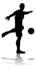 A soccer or football player in silhouette