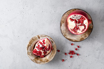 Composition with ripe pomegranates on grey background. Space for text