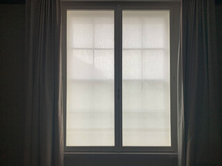 Open window with white curtains 