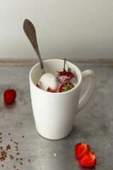 fresh strawberries with ice cream in white cup. Copy space. Homemade dessert. healthy breakfast with yogurt and strawberries